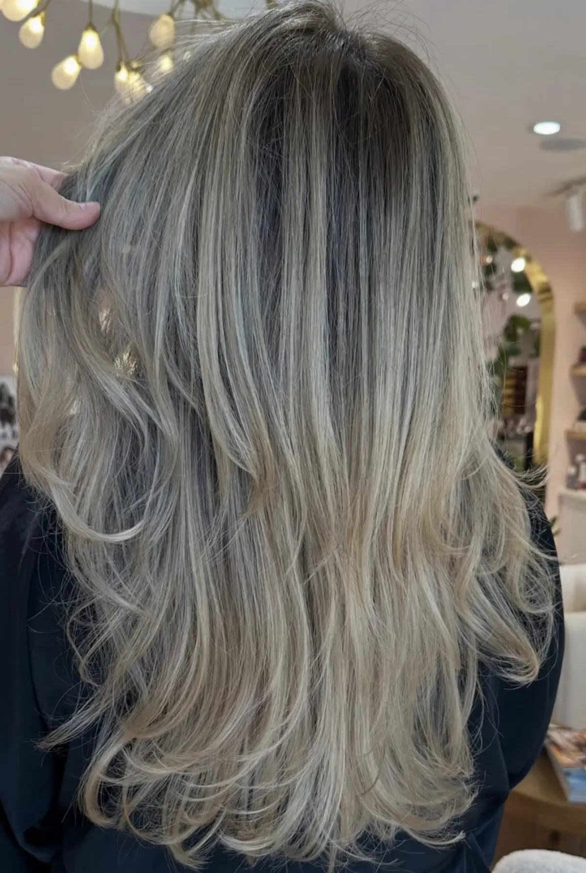 Bright blonde foil highlights with fine dimensional pieces on long layered hair at Studio A Salon in Houston