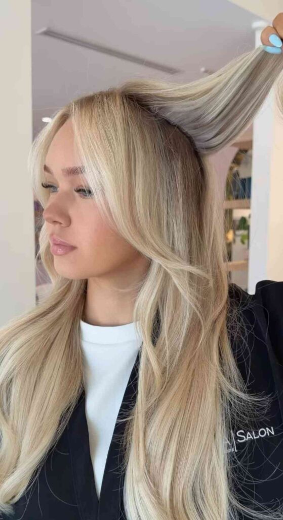Long blonde hair extensions styled at a Houston salon