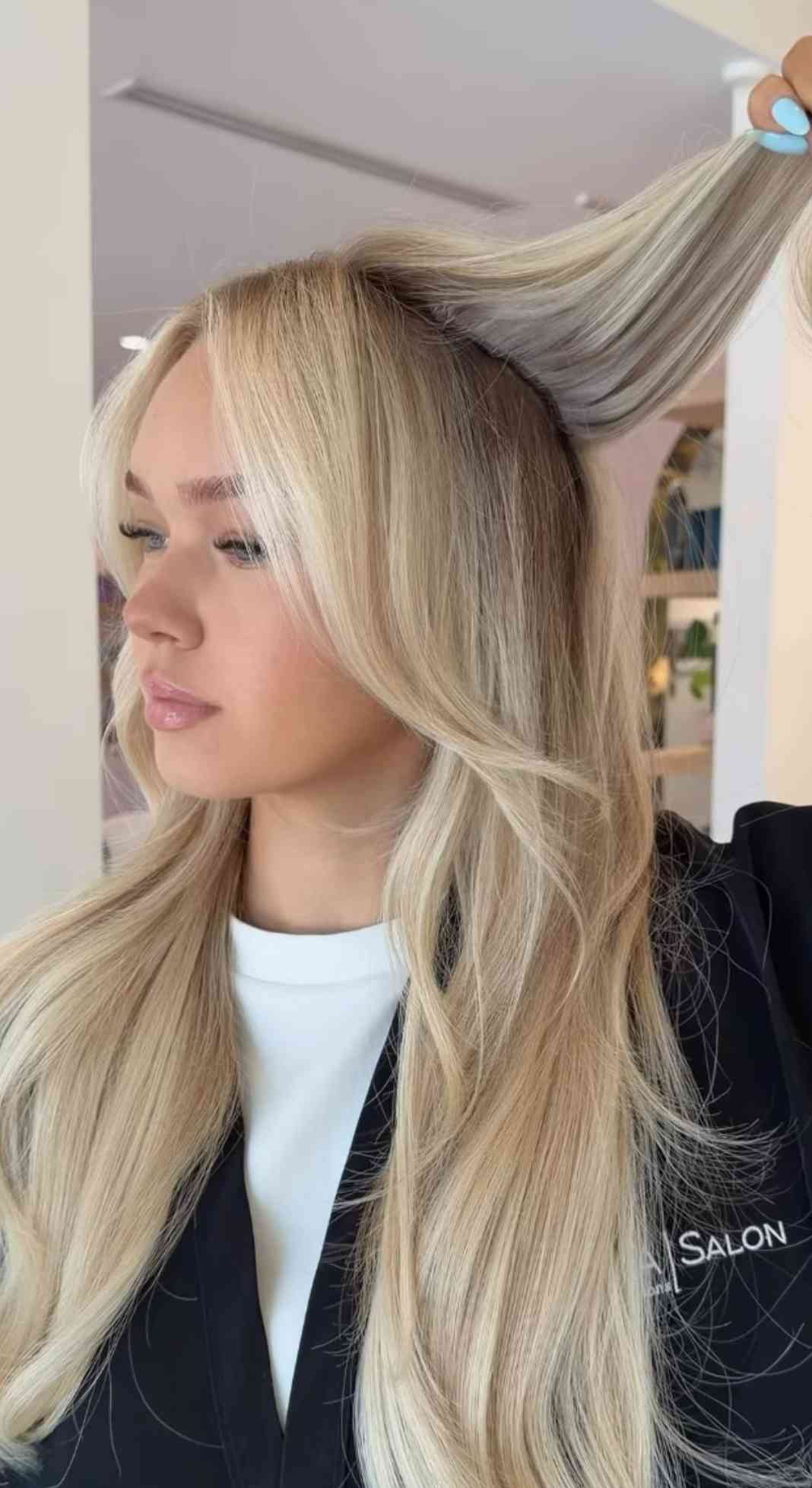 Long blonde hair extensions styled at a Houston salon