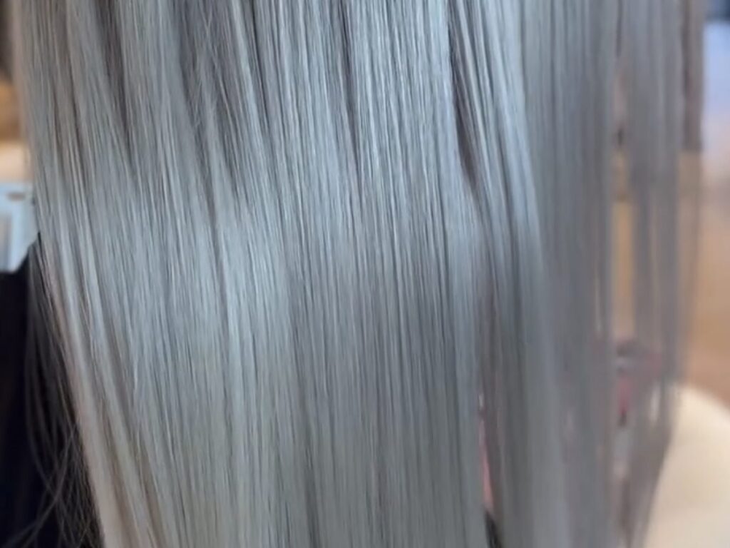 Silver toned color-treated hair smoothed at a Houston hair salon in Woodland Heights
