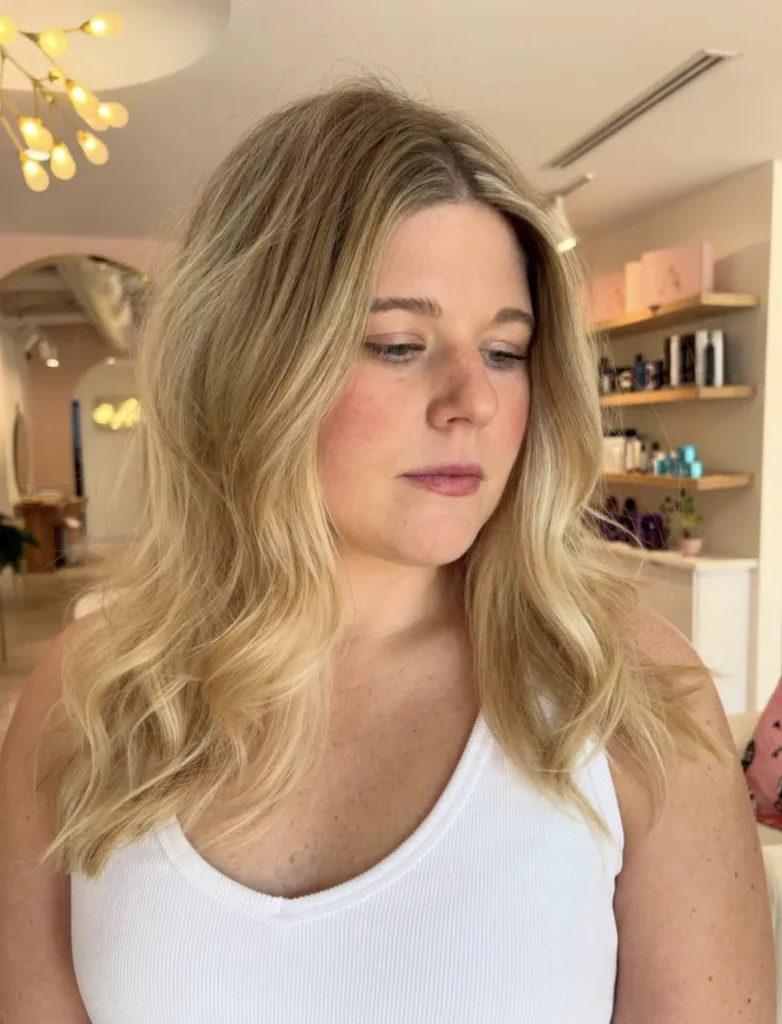 Honey blonde with a soft shadow root and face-framing highlights, a fall hair color for Houston blondes