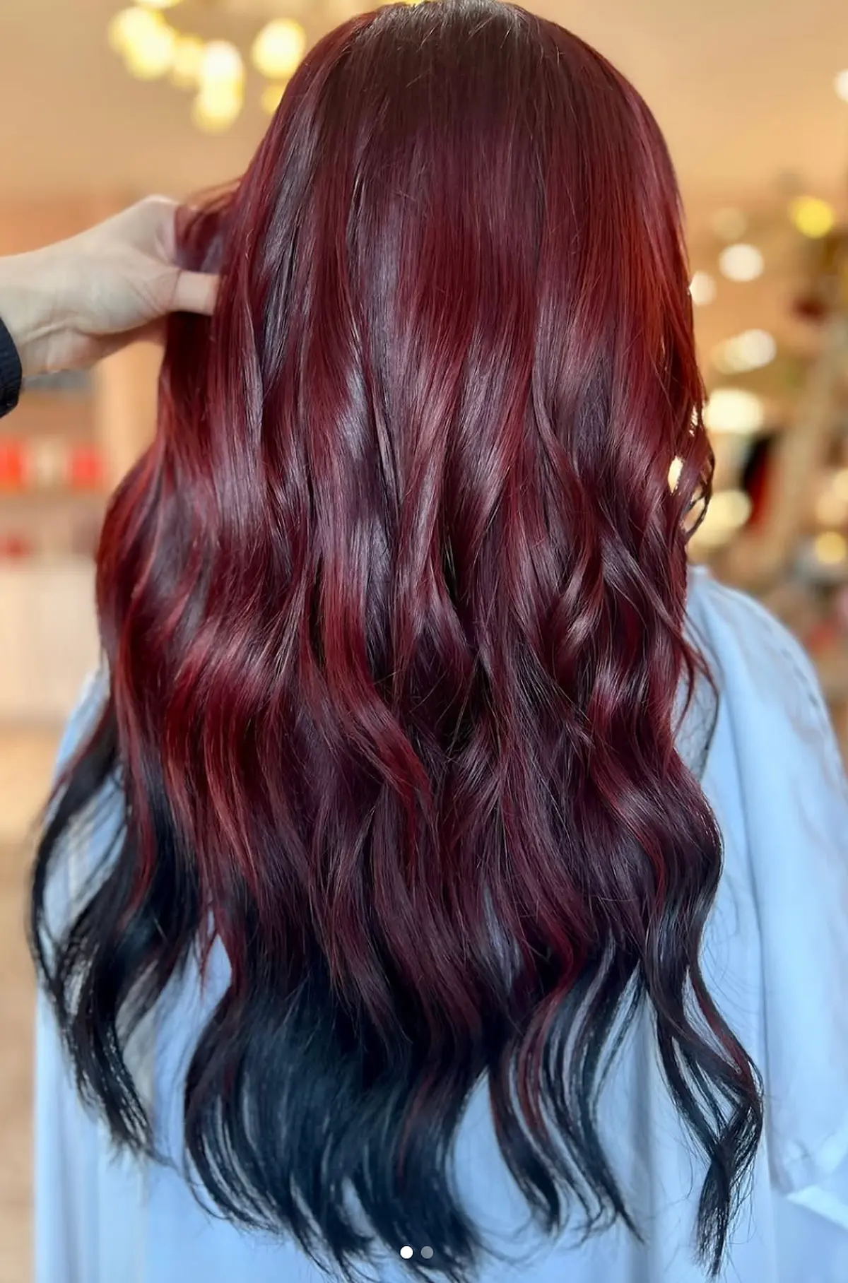 Glossy cherry red hair with dark ends after a color and gloss at Studio A Salon in Houston